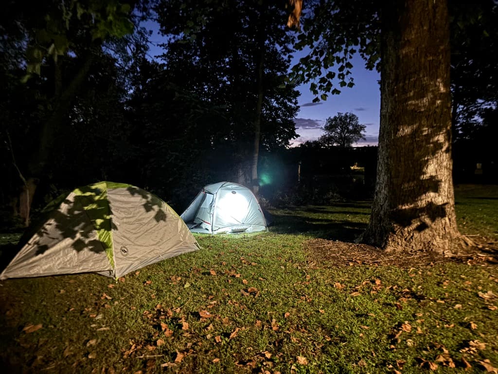 Lit campsite tents at night