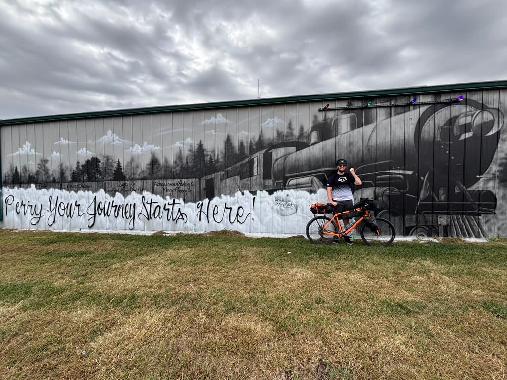 Rider and orange bike at train mural
